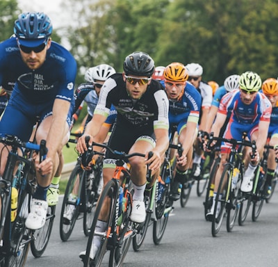 group of cyclist on asphalt road