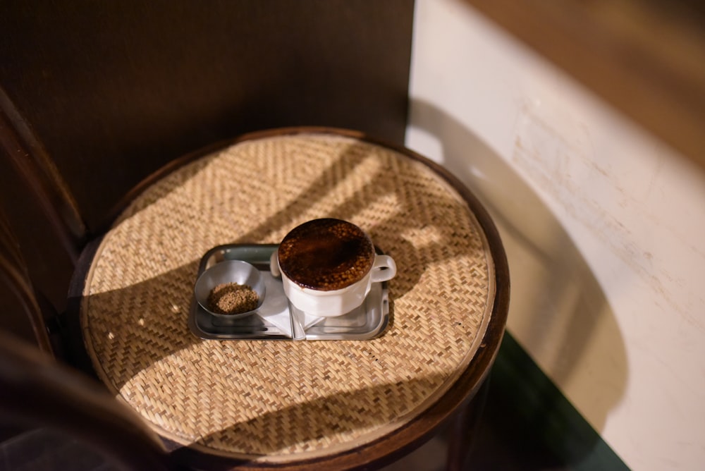 ceramic cup filled with brown liquid