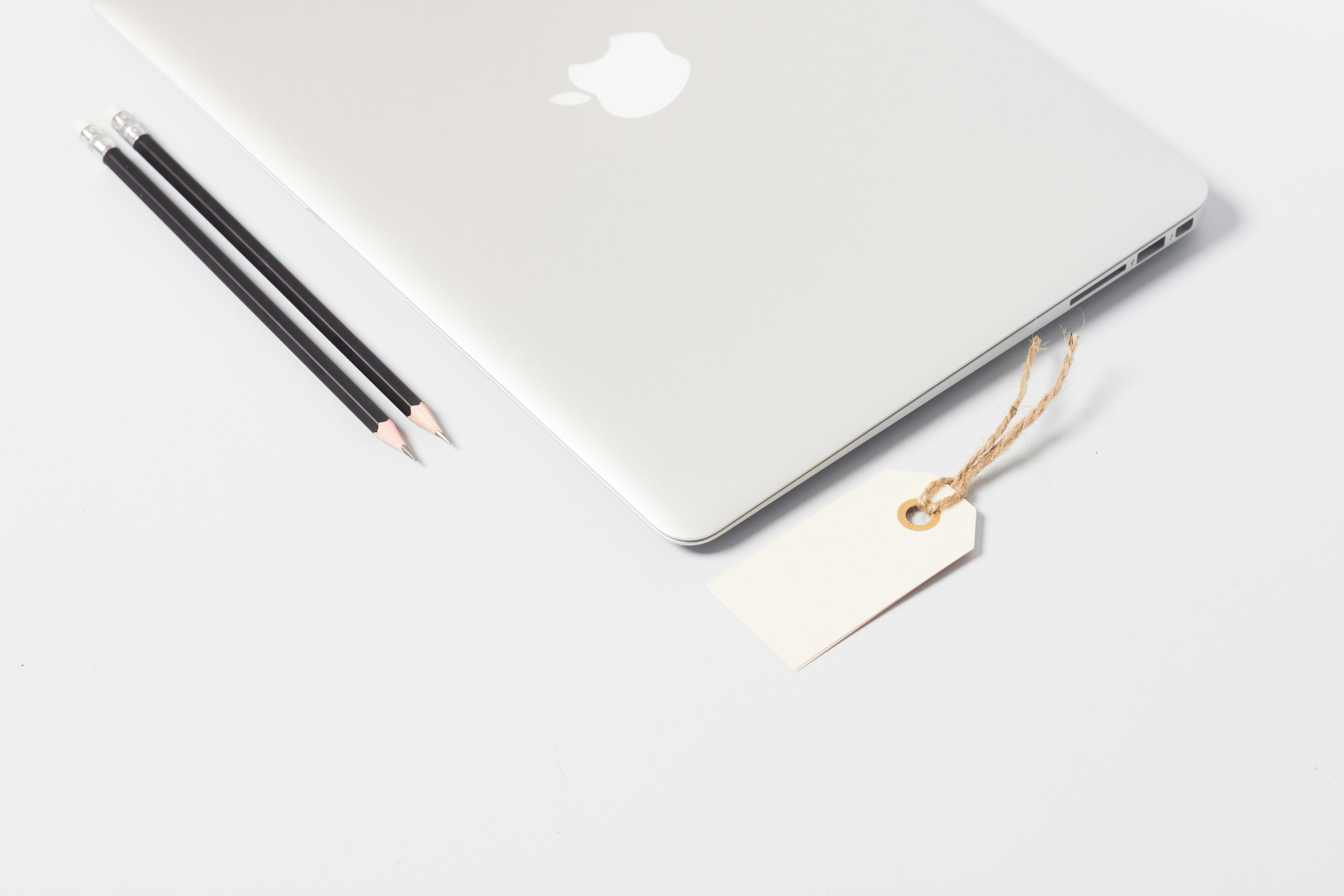 closeup photo of MacBook Air near pencils