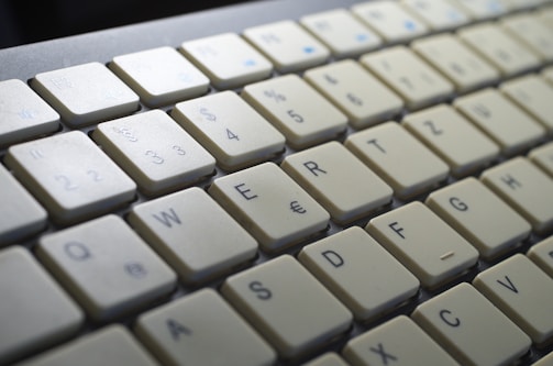 Close-up of hands typing on a laptop with European Union symbols on the screen.