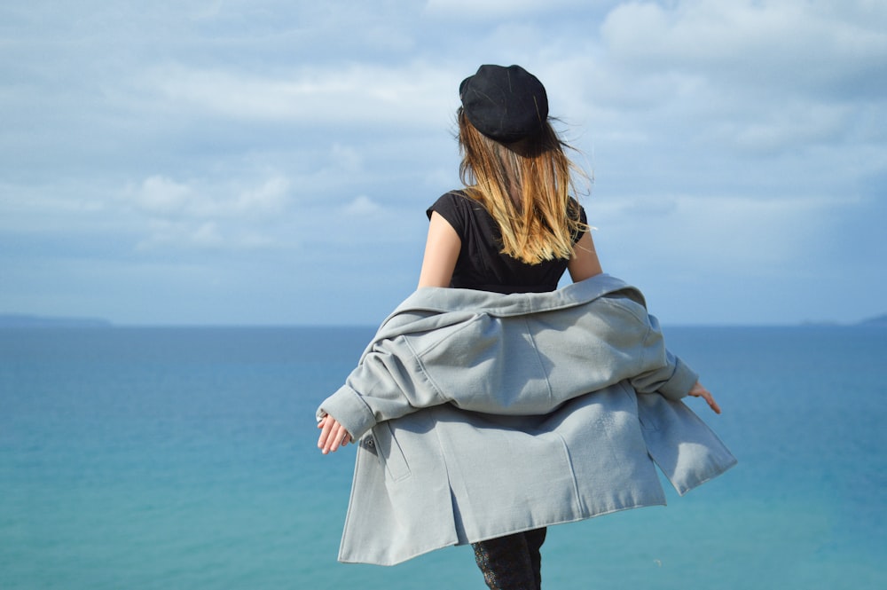 woman in black T-shirt stand near body of water