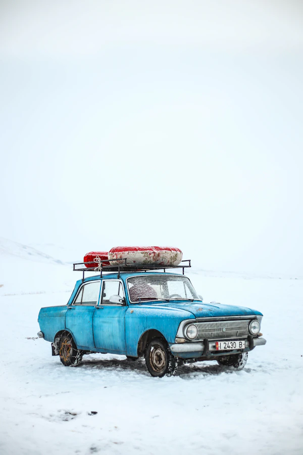 Blue sedan on snow