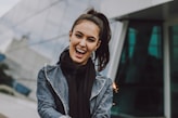woman wearing gray denim jacket and black scarf
