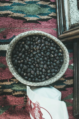 A cozy setting with a coffee bag and a woven Yemeni basket beside it, highlighting cultural roots.