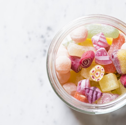 assorted-color candies on container