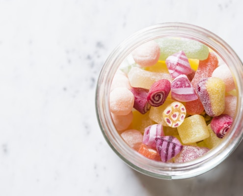 assorted-color candies on container