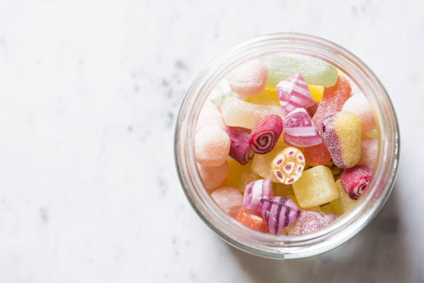 Assorted-color candies on container