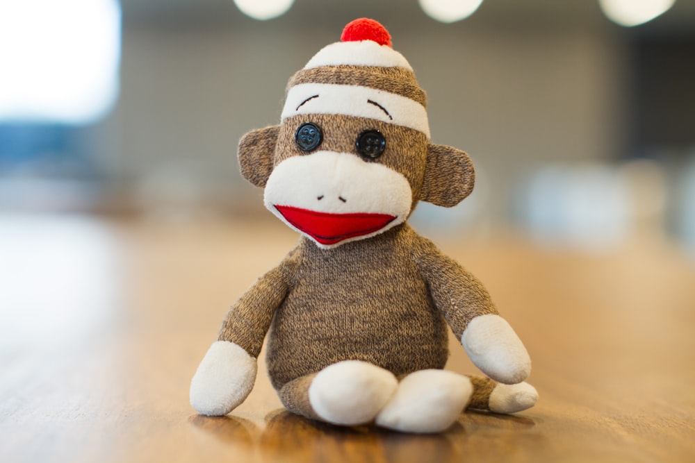 Juguete de peluche Sock Monkey en panel marrón