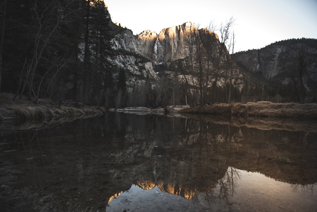 rock mountain reflected on water