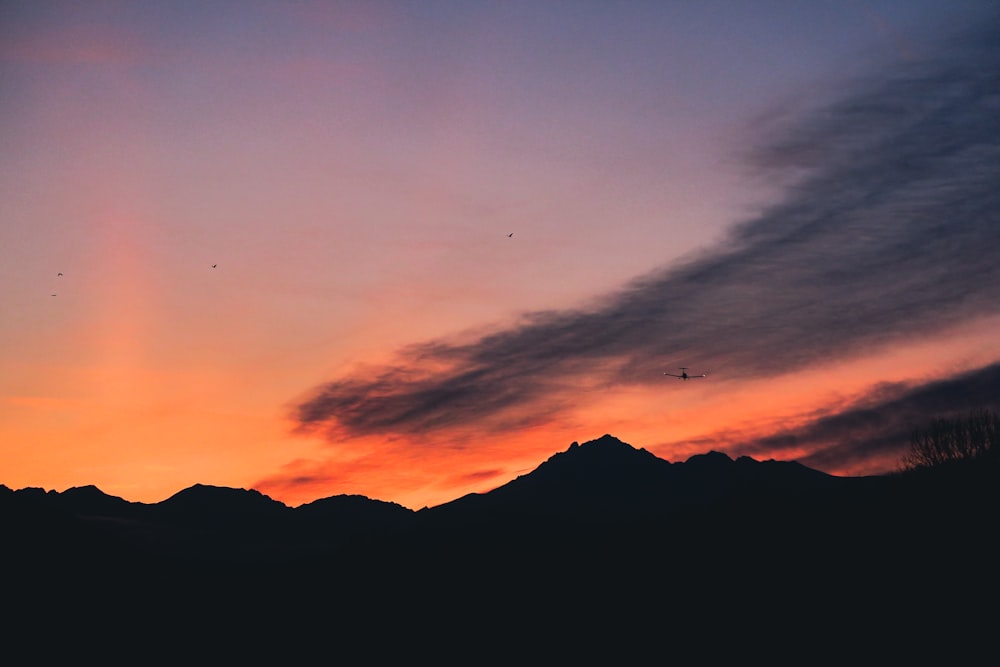 silhouette of mountain under white clouds