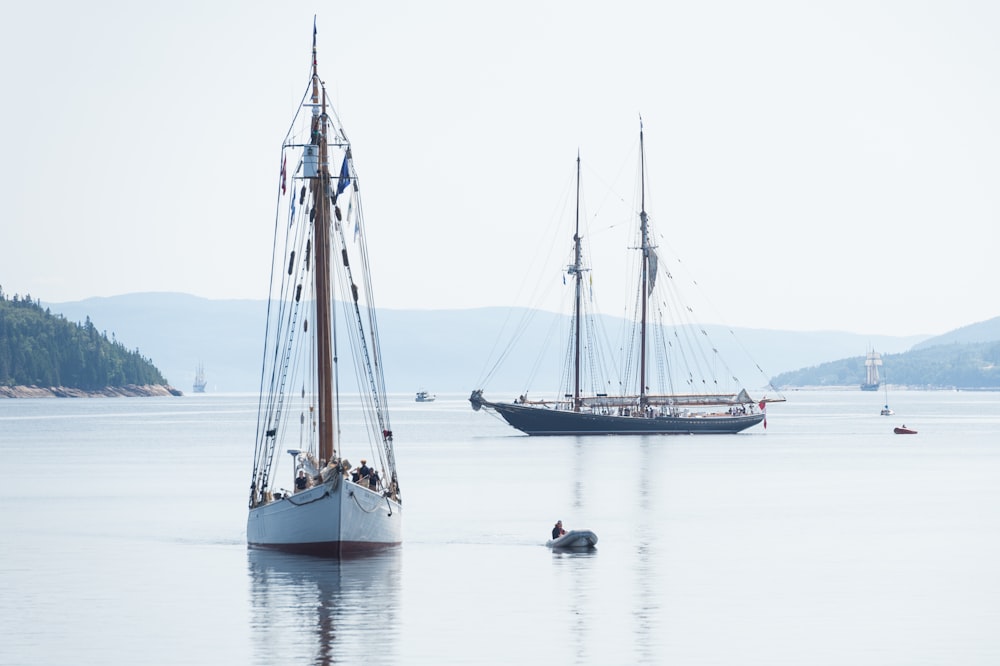 two gray and white boats in body of water