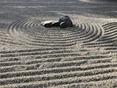Peaceful zen garden with stones and bamboo, evoking tranquility.