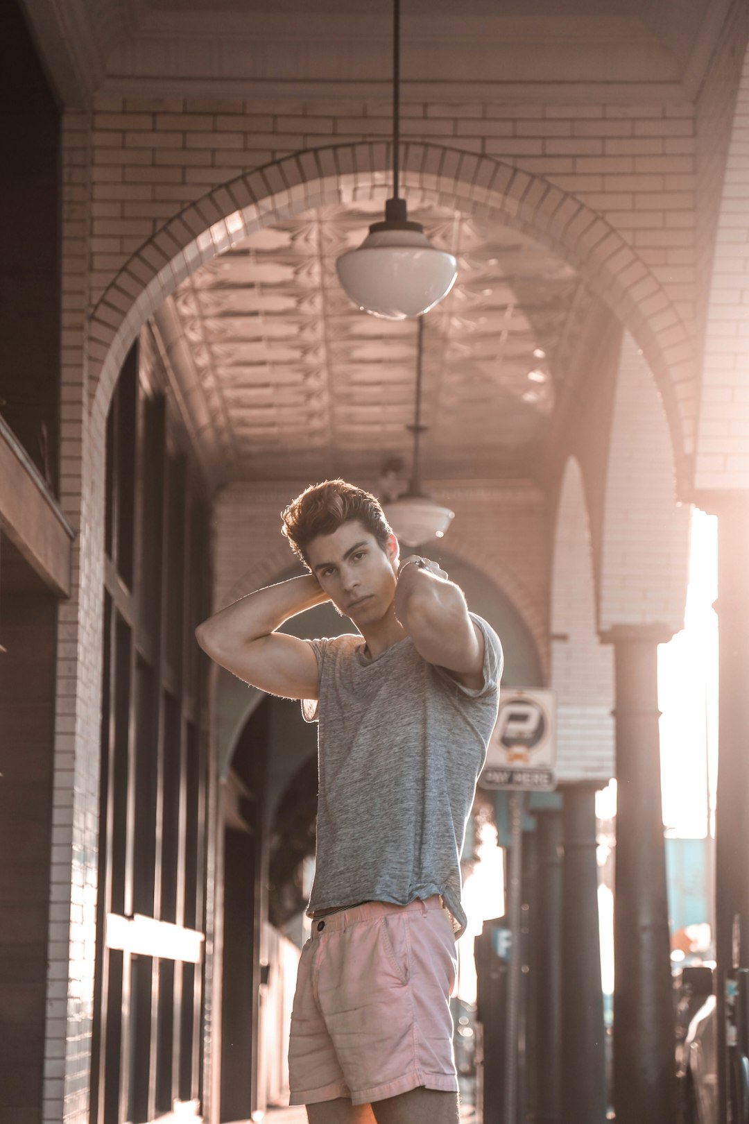 man standing under white ceiling lamp during daytime