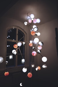 A modern chandelier installation in a home.