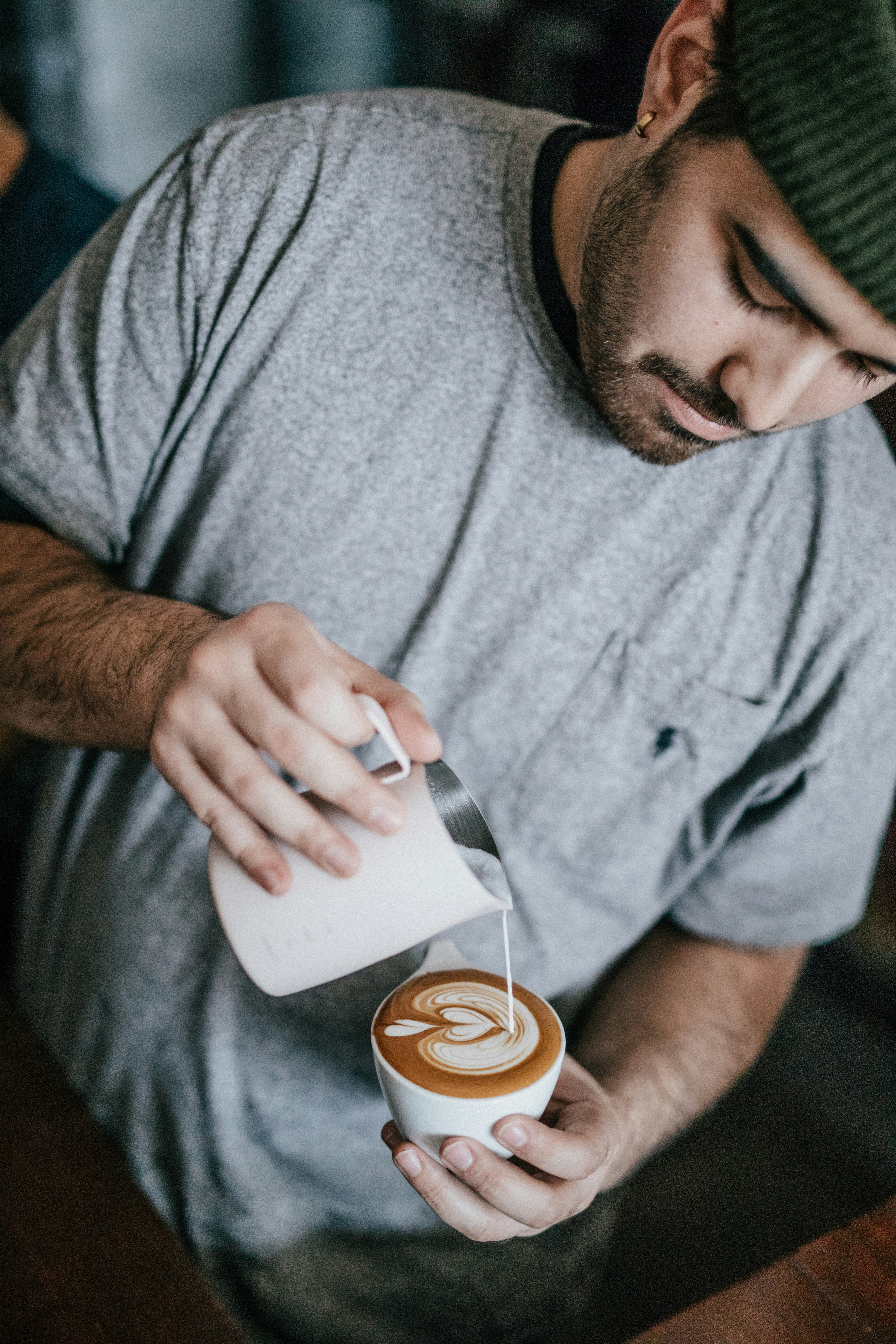 man in gray crew-neck T-shirt making cappuccino
