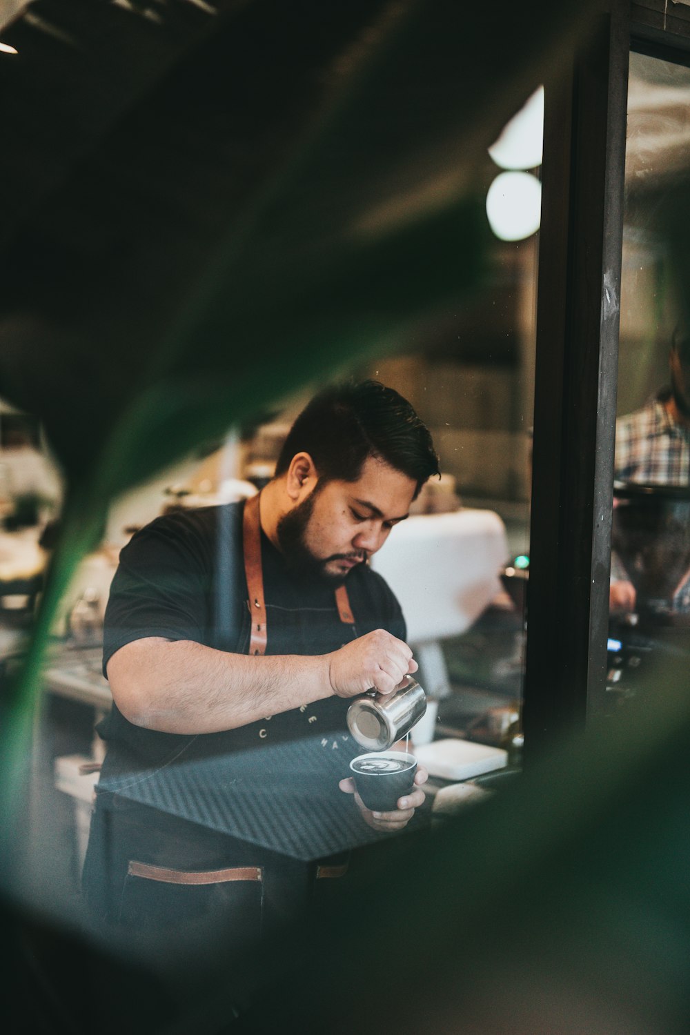 man pouring coffee in cup