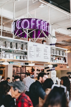A vibrant coffee shop bustling with happy customers and digital marketing visuals overlay.