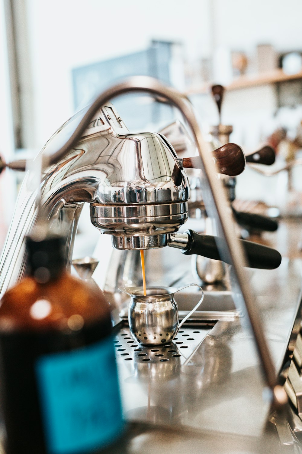 stainless steel espresso maker filling a cup