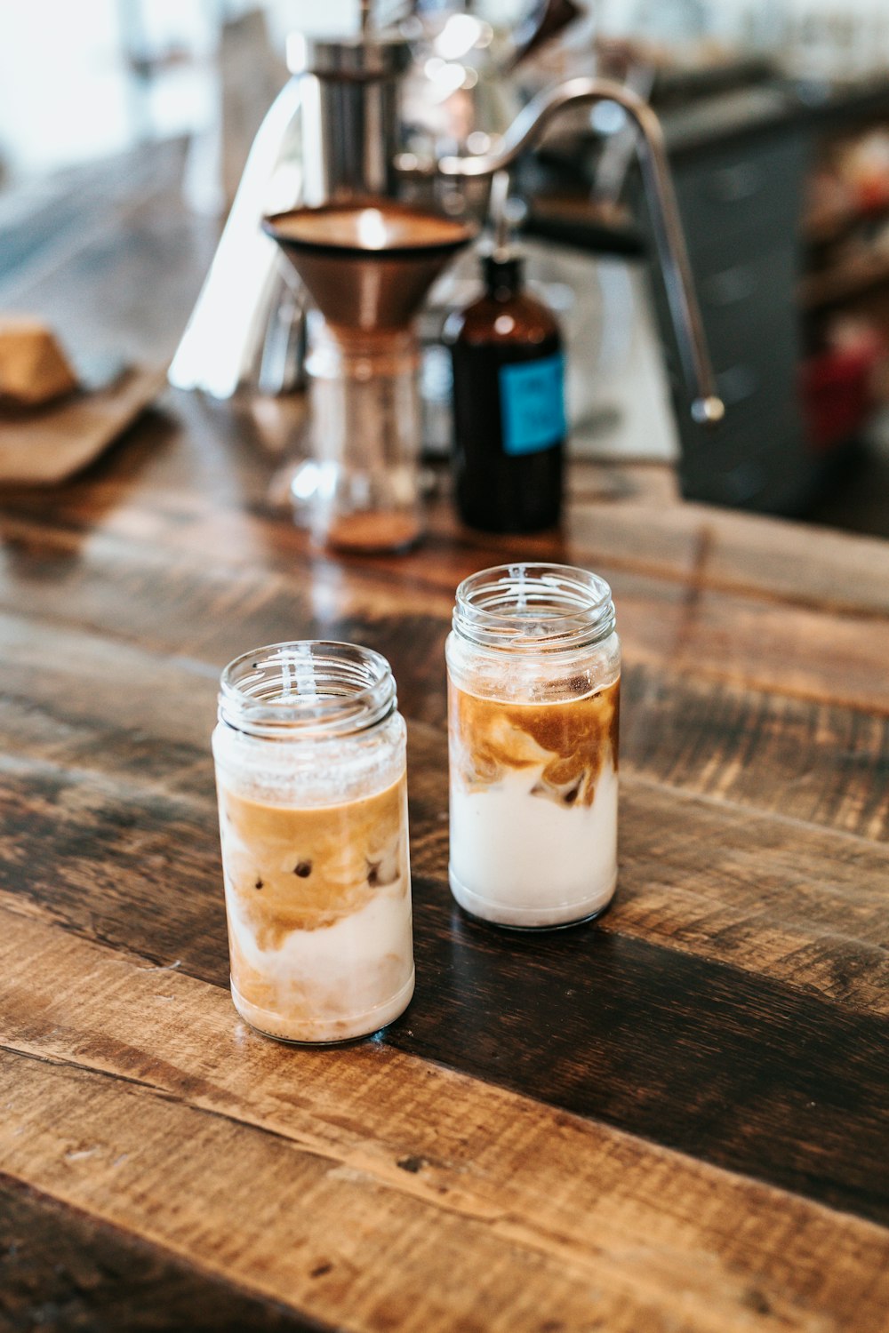 two clear glass jars on brown table