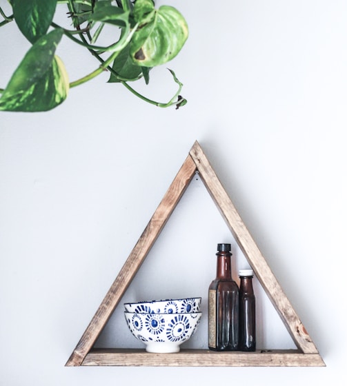 two white-and-blue ceramic bowls on wooden rack