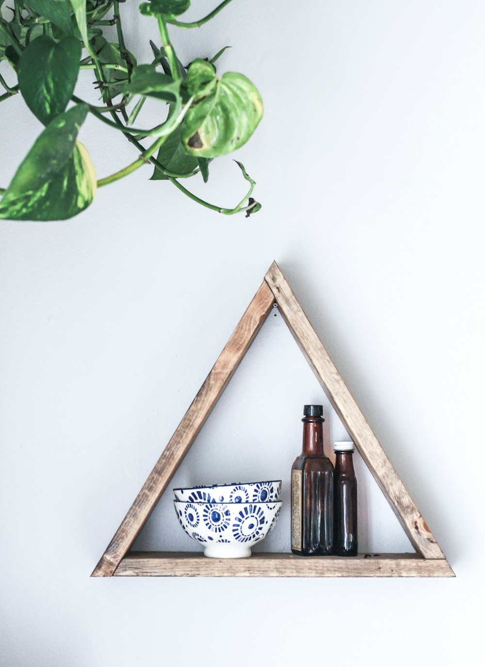 two white-and-blue ceramic bowls on wooden rack