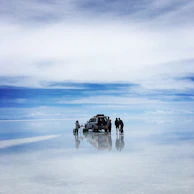 people standing near silver SUV