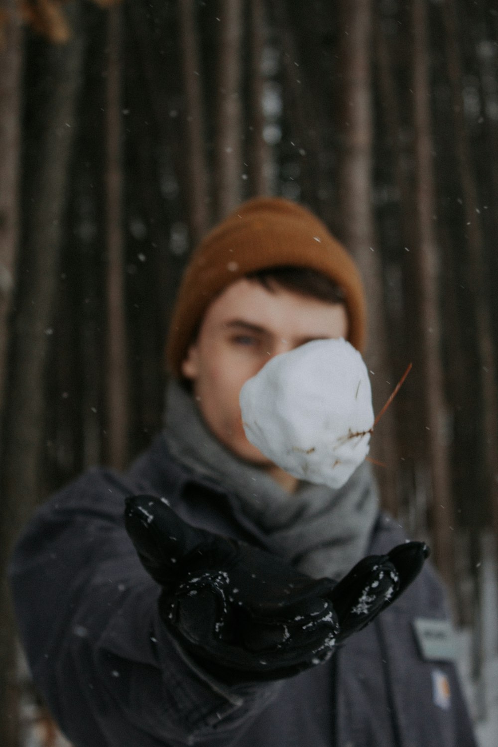 man holding snow ball