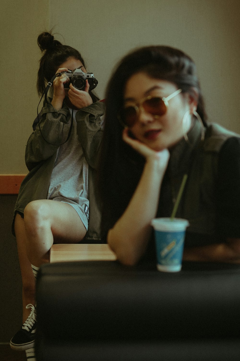 woman sitting on chair while taking photo