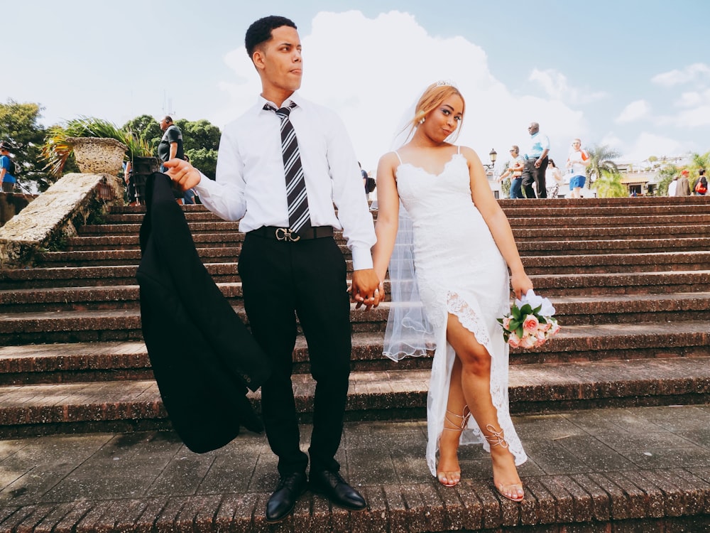 men walking beside the woman while holding her hands