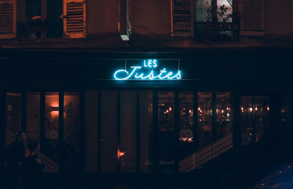 Les Justes lighted neon signage above store