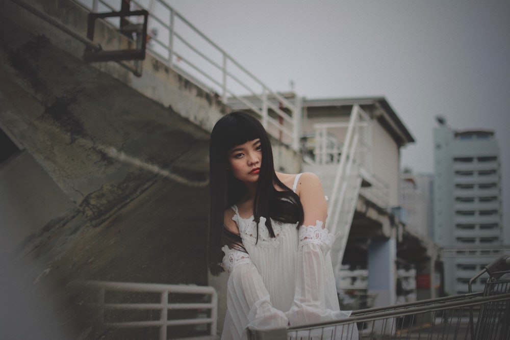 photography of woman holding shopping cart outdoors