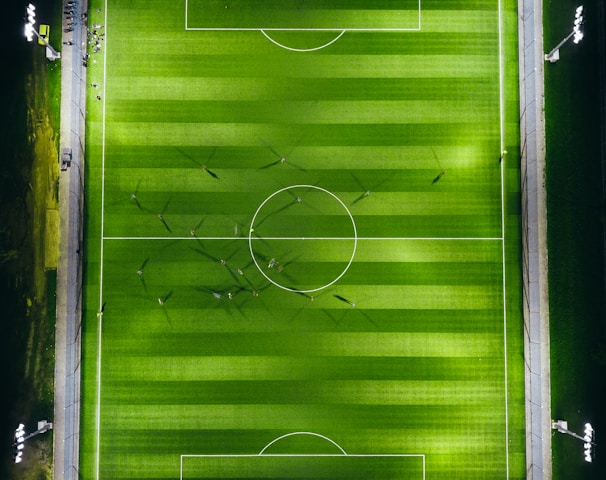 bird's-eye view photography of green soccer field with lights