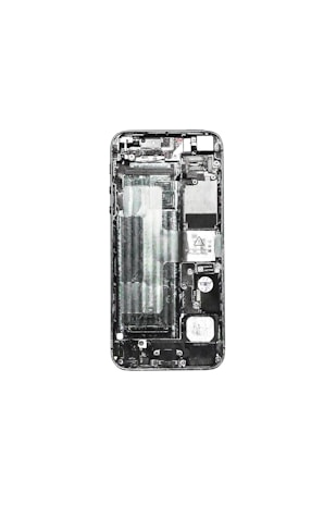 A disassembled view of a smartphone displaying its internal components such as the circuit board, battery compartment, and various connectors. The phone case is removed, exposing the intricate layout of electronic parts.