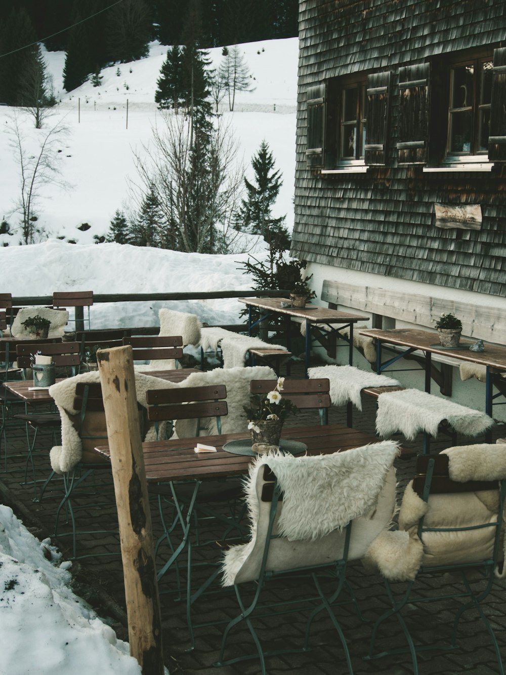 closeup photo of brown table with chair set outside the house