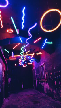 A neon-lit hallway with swirling pastel clouds and glitchy pixel art figures floating.