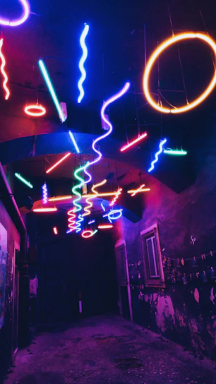 A neon-lit hallway with swirling pastel clouds and glitchy pixel art figures floating.