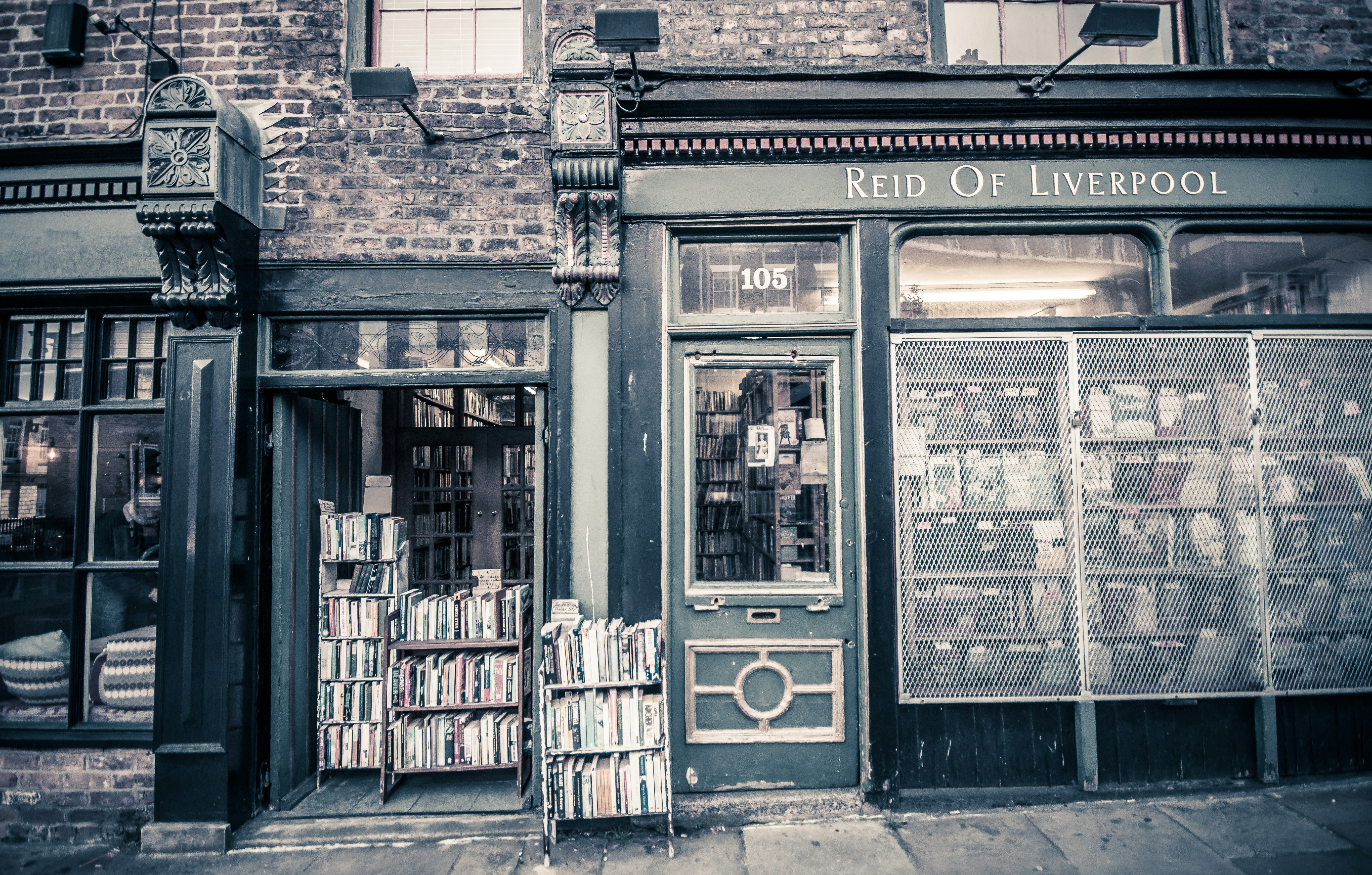 grayscale photo of Reid of Liverpool store signage at daytime