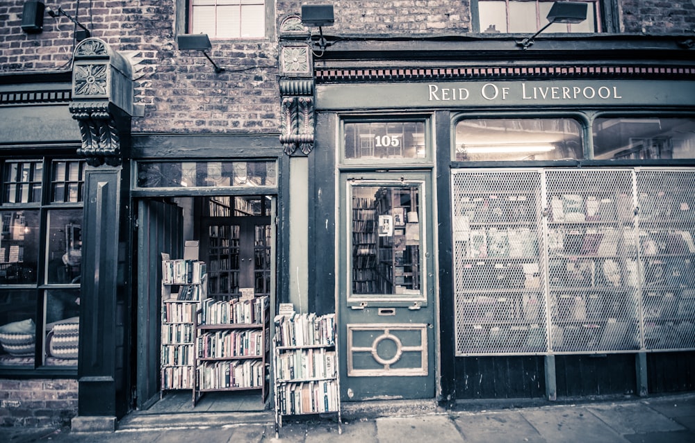 grayscale photo of Reid of Liverpool store signage at daytime