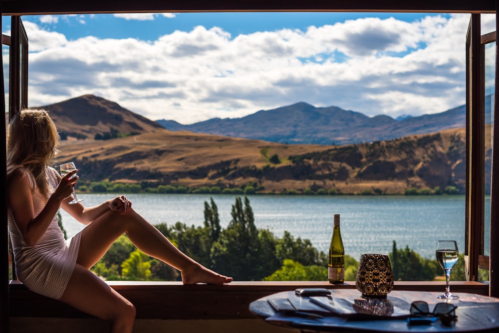 woman drinking in mountain views