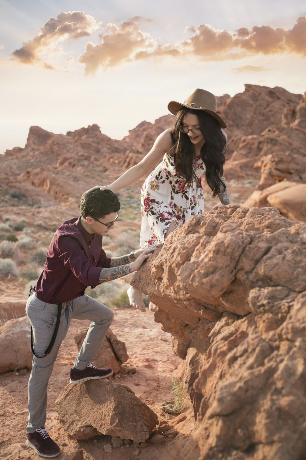 man and woman climbing on rocks