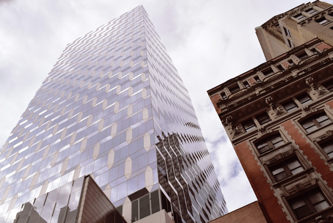 brown concrete building under white clouds during daytime