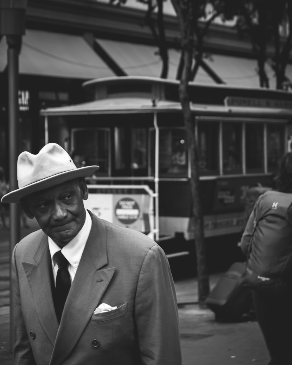 grayscale photo of man wearing suit jacket