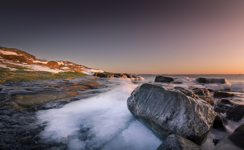 aerial view of gray boulders near seashore