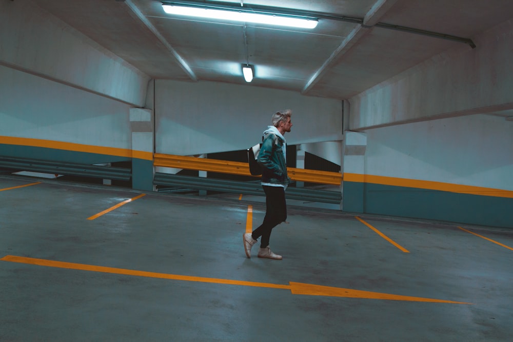 man walking on parking hall