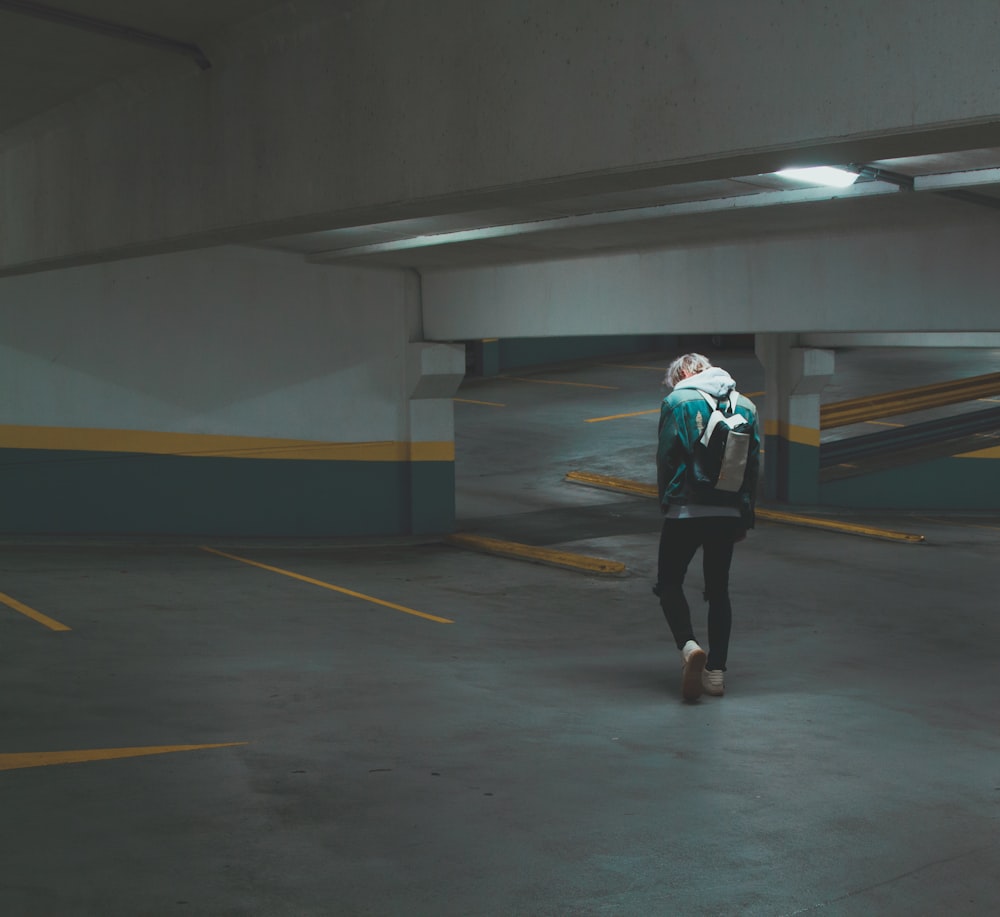 person walking on underground parking area