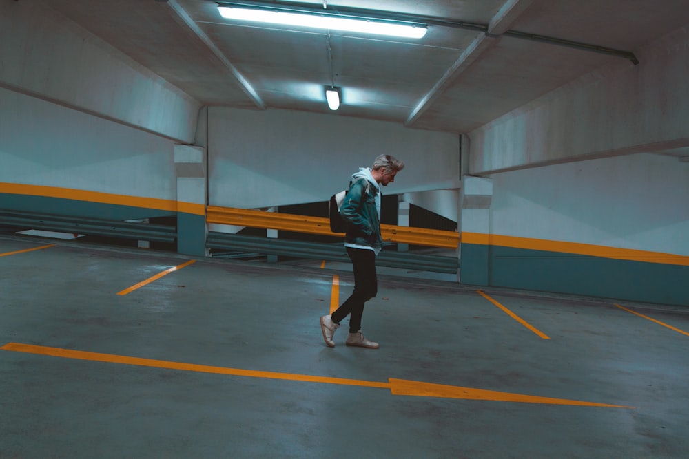 man walking on slope parking lot