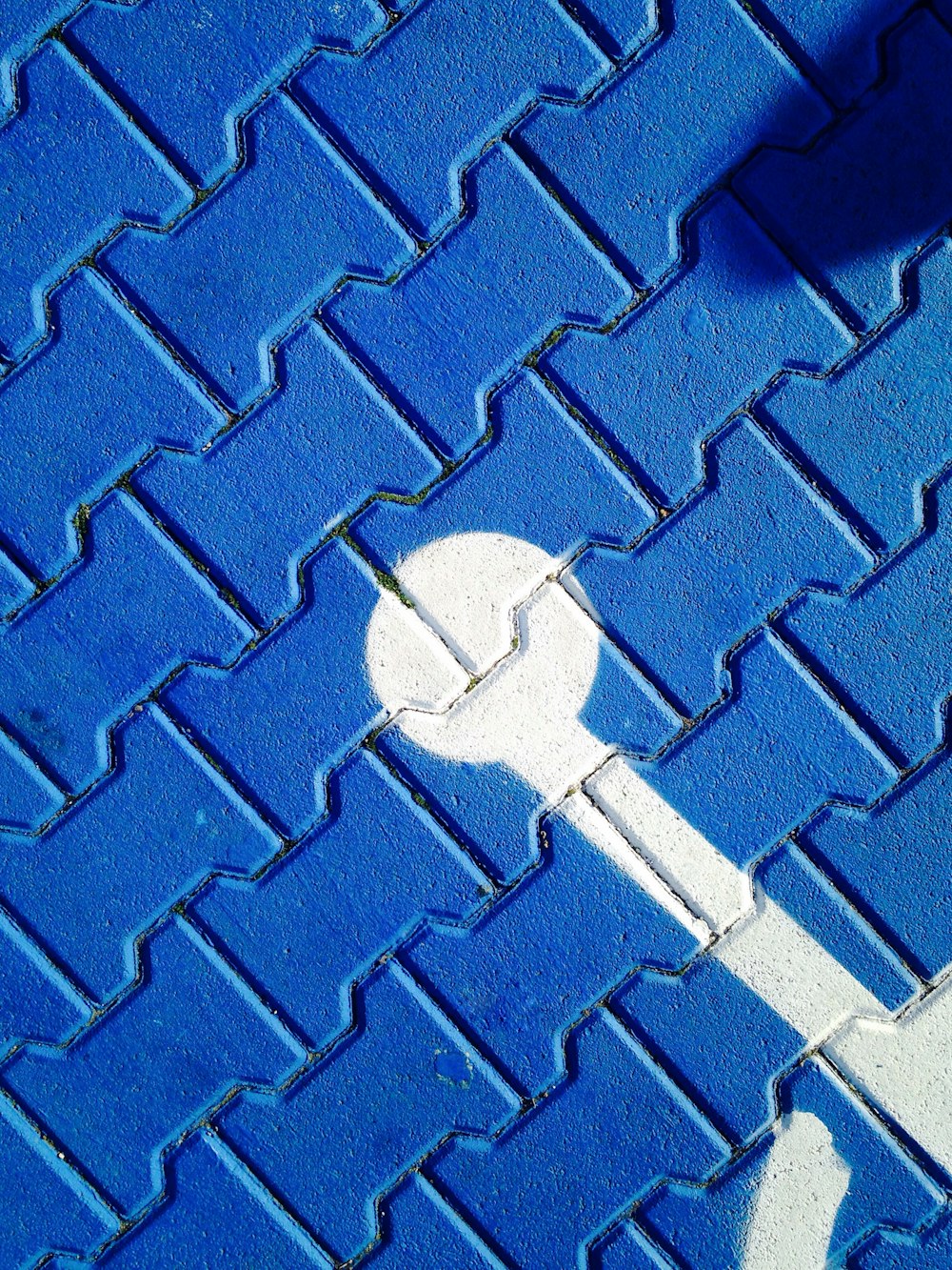 person with wheelchain marked on purple pavement