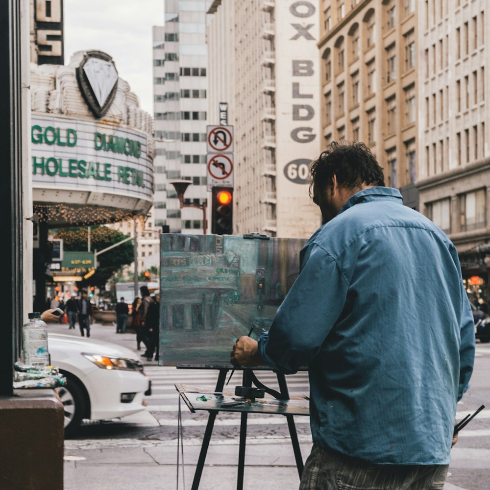 man painting the city