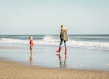 woman and child standing on seashore