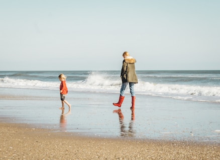 woman and child standing on seashore